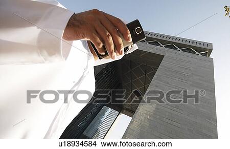 dishdash, businessman, shumagh, tower, business, trade, arabic View Large Photo Image Picture - dishdash, businessman, shumagh, tower, business, trade, arabic. Fotosearch