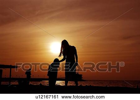 Stock Image - sunset, sunrise, rise, dubai, beach, happy, familly. Fotosearch