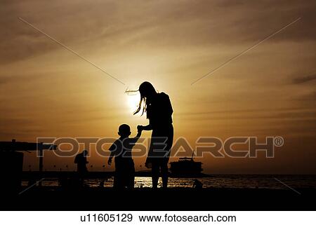 Stock Photo - sunset, sunrise, rise, dubai, beach, happy, familly. Fotosearch