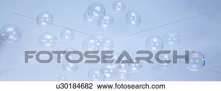 Stock Image - Bubbles with blue background. Fotosearch