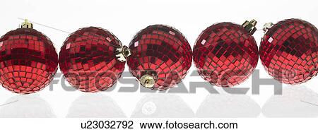Stock Image - Five red Christmas Baubles in a row. Fotosearch