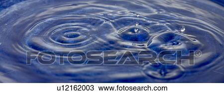 Stock Image - Water droplets in bowl. Fotosearch