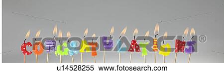 Stock Photography - Candle letters lit up and spelling out congratulations. Fotosearch