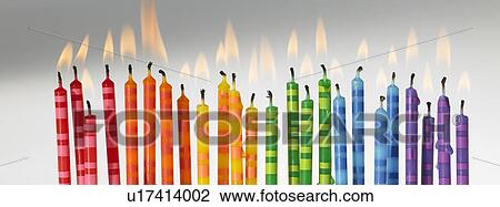 Stock Image - Colourful candles lit up in a row. Fotosearch