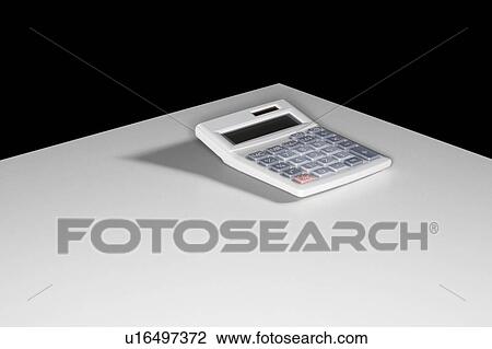 A calculator sitting on a white table. View Large Photo Image Stock Image - A calculator sitting on a white table.. Fotosearch