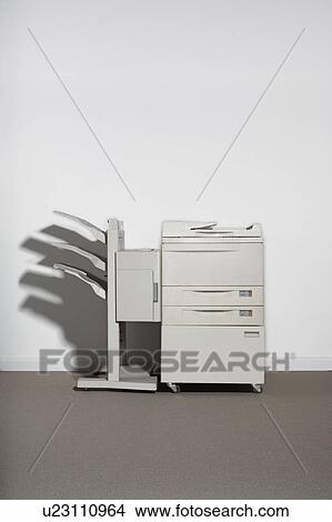 Picture - A photocopier against a white wall.. Fotosearch