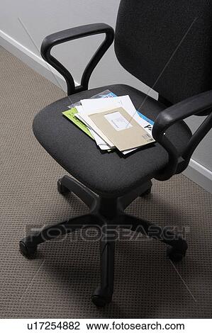A pile of papers on an office chair. View Large Photo Image Stock Image - A pile of papers on an office chair.. Fotosearch