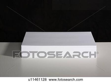 A pile of white paper sitting on a table. View Large Photo Image Stock Photo - A pile of white paper sitting on a table.. Fotosearch