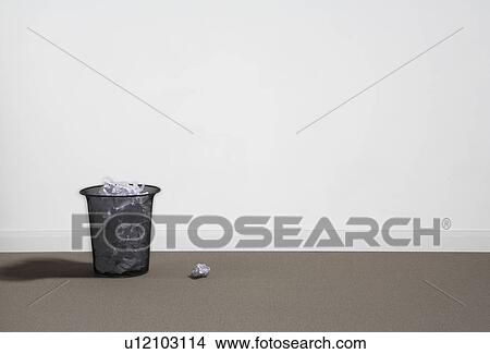 A rubbish basket full of waste paper. View Large Photo Image Picture - A rubbish basket full of waste paper.. Fotosearch
