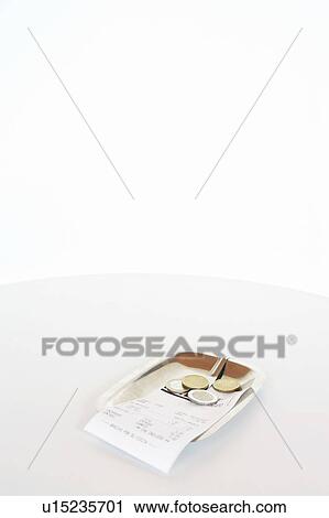 Stock Image - Bill with change in a saucer.. Fotosearch