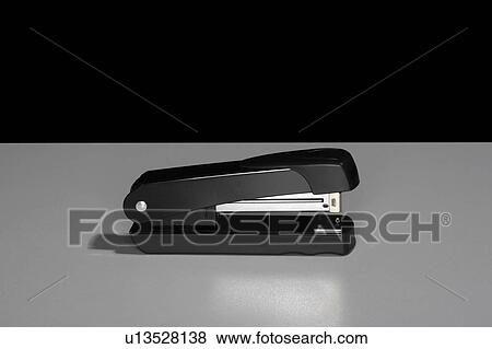 Stock Photo - Black stapler sitting on a table.. Fotosearch