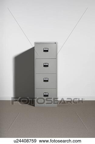 Filing cabinet against wall. View Large Photo Image Stock Photo - Filing cabinet against wall.. Fotosearch