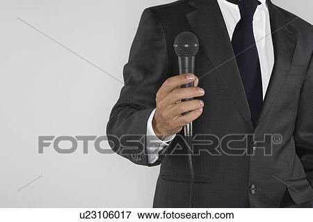 Stock Photo - Man holding a microphone.. Fotosearch