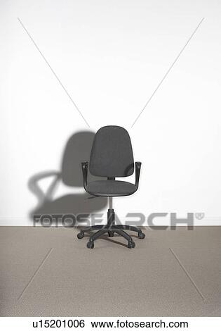 Office chair against a wall. View Large Photo Image Stock Photograph - Office chair against a wall.. Fotosearch