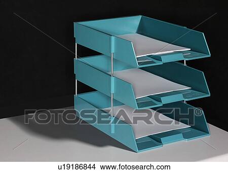 Set of three in and out trays sitting on a table. View Large Photo Image Picture - Set of three in and out trays sitting on a table.. Fotosearch