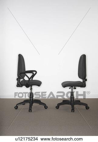 Two office chairs facing each other. View Large Photo Image Picture - Two office chairs facing each other.. Fotosearch