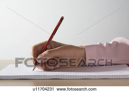 Woman's hand with a pencil on a pad. View Large Photo Image Stock Image - Woman's hand with a pencil on a pad.. Fotosearch