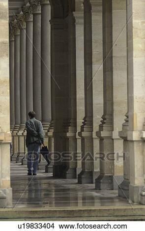 Rear view of a man standing in a historical building in Prague View Large Photo Image Picture - Rear view of a man standing in a historical building in Prague. Fotosearch