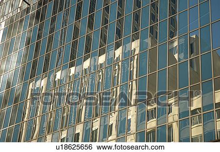 Stock Photograph - Glass front of a high rise building. Fotosearch