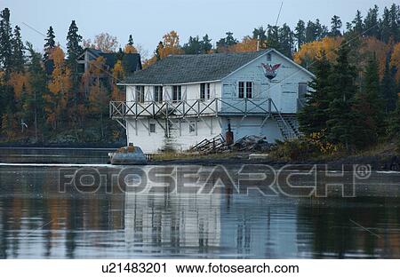 Stock Image - Boathouse on Lakeshore. Fotosearch