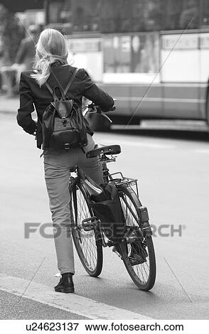 Rear view of a young woman on a bicycle in Paris, France View Large Photo Image Stock Photo - Rear view of a young woman on a bicycle in Paris, France. Fotosearch