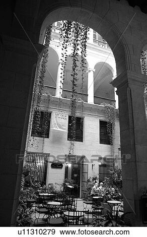 Stock Photo - View of an outdoor cafe with an arched entrance, Havana, Cuba. Fotosearch
