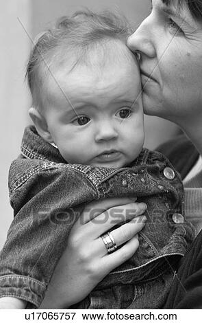 Woman holding a baby in Prague View Large Photo Image Stock Photo - Woman holding a baby in Prague. Fotosearch