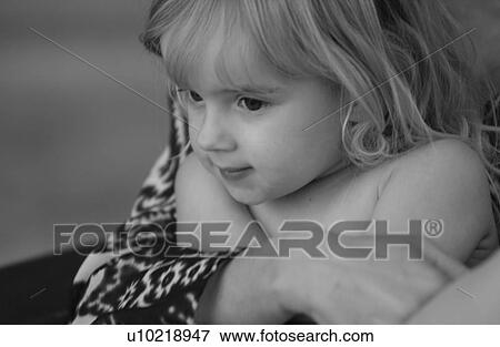 Stock Photo - Young girl being held by an adult. Fotosearch