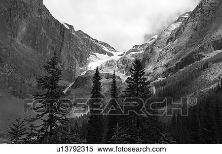 Stock Photography - Panoramic view of a snow capped mountain (black and white), Rocky Mountains, Canada. Fotosearch