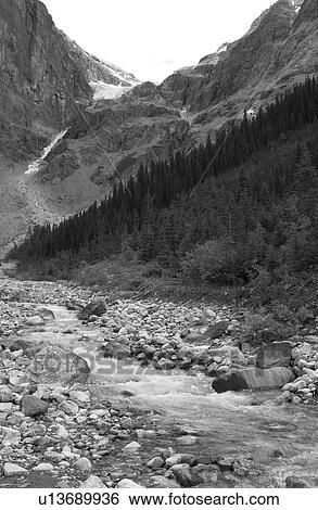 Stream running at the base of a mountain (black and white), Rocky Mountains, Canada View Large Photo Image Stock Photograph - Stream running at the base of a mountain (black and white), Rocky Mountains, Canada. Fotosearch