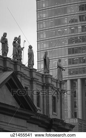 Stock Image - Statues on top of a building in Montreal, Canada. Fotosearch