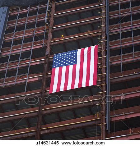 Stock Photography - American Flag suspended from the side of a building, New York City. Fotosearch