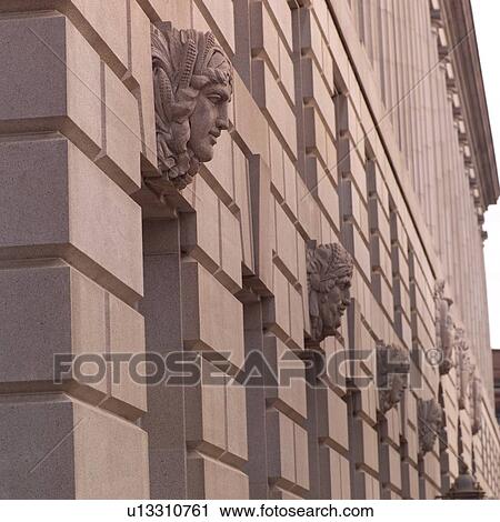 Stock Image - Carvings of Heads on Building in San Francisco. Fotosearch