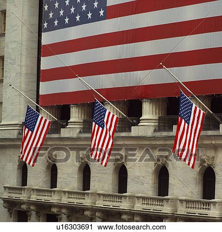 Stock Image - American Flag outside New York Stock Exchange, New York City. Fotosearch