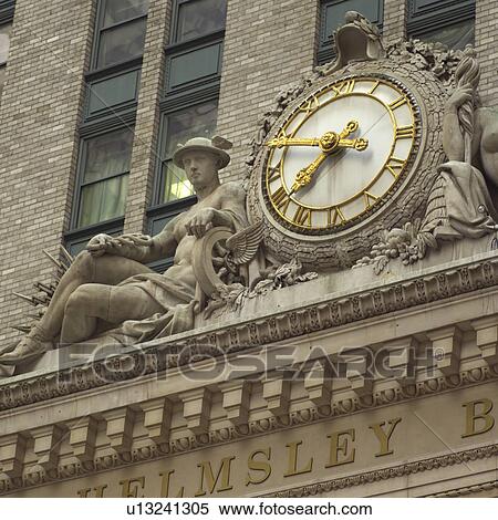 Stock Photography - Clock and sculpture on Helmsley Building, New York City. Fotosearch