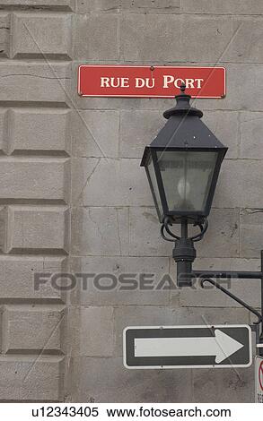 Lamp post on building wall with a sign board in Montreal, Canada View Large Photo Image Stock Photography - Lamp post on building wall with a sign board in Montreal, Canada. Fotosearch