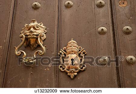 Close-up of brass door knocker and keyhole on a door View Large Photo Image Stock Photo - Close-up of brass door knocker and keyhole on a door. Fotosearch