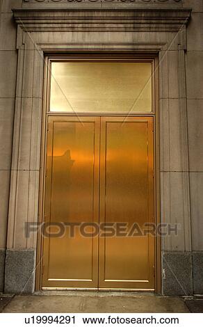 Golden metal doors in a building View Large Photo Image Stock Image - Golden metal doors in a building. Fotosearch