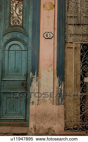 Stock Photography - View of a doorway on the facade of a dilapidated building. Fotosearch