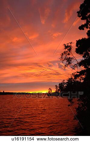 Crimson sky over Lake of the Woods View Large Photo Image Picture - Crimson sky over Lake of the Woods. Fotosearch