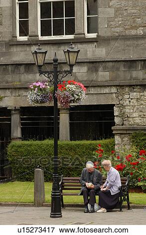 Stock Photo - Elderly couple sitting on a bench. Fotosearch