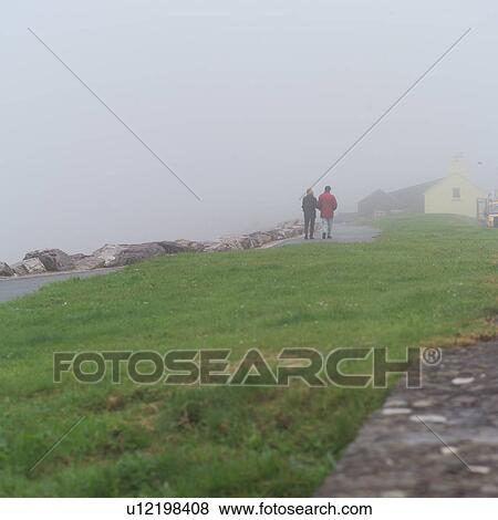 Stock Photo - Ireland - Ring of Kerry - Couple walking along shore. Fotosearch