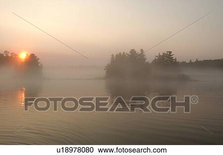Stock Image - Lake of the Woods at sunrise. Fotosearch