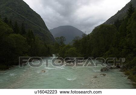 River flowing between mountains in Slovenia View Large Photo Image Stock Image - River flowing between mountains in Slovenia. Fotosearch