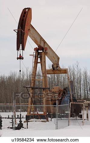 Picture - Oil Well in Field of Snow in Alberta Canada. Fotosearch