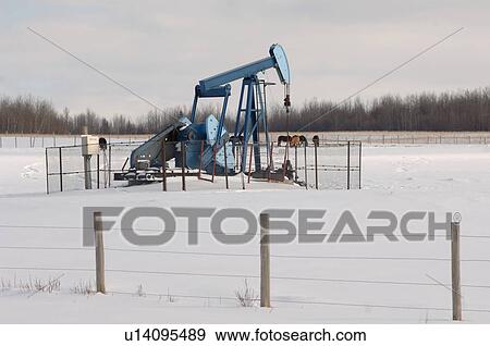 Oil Well in Field of Snow in Alberta Canada View Large Photo Image Stock Photo - Oil Well in Field of Snow in Alberta Canada. Fotosearch