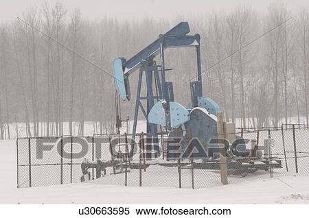 Oil Well in Field of Snow in Alberta Canada View Large Photo Image Stock Photography - Oil Well in Field of Snow in Alberta Canada. Fotosearch