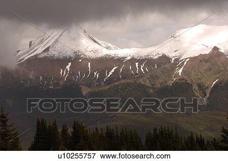 Snow Capped Mountain Peak, Jasper National Park, Canada View Large Photo Image Stock Photo - Snow Capped Mountain Peak, Jasper National Park, Canada. Fotosearch