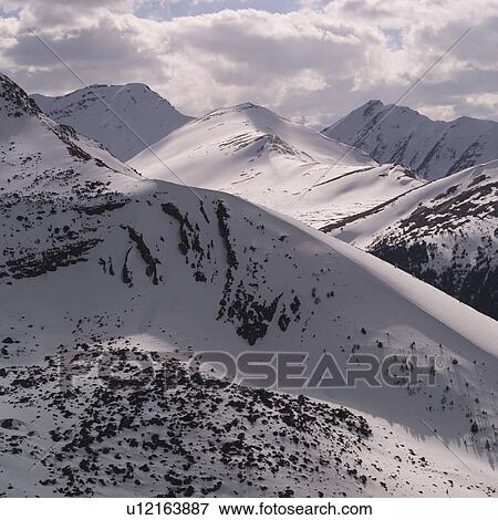 Snowy slopes of Rocky Mountains View Large Photo Image Stock Photo - Snowy slopes of Rocky Mountains. Fotosearch