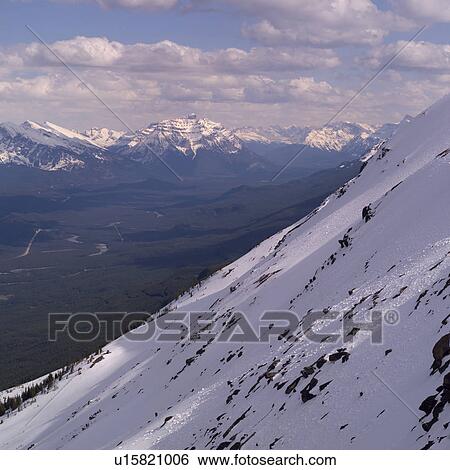 Stock Photograph - Snowy slopes of Rocky Mountains. Fotosearch